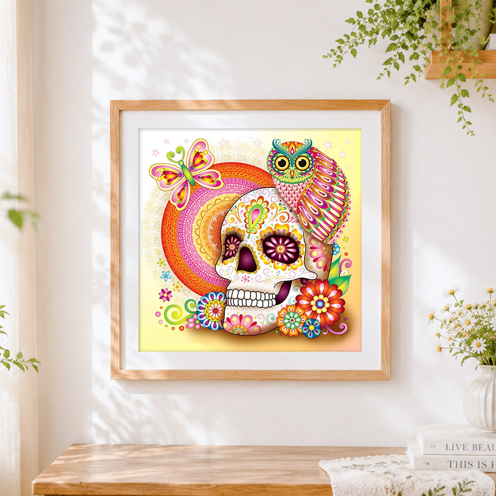 Finished sugar skull with owl and mandala cross stitch artwork displayed