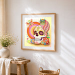 Sugar skull with owl and mandala cross stitch artwork displayed on wall as home decor