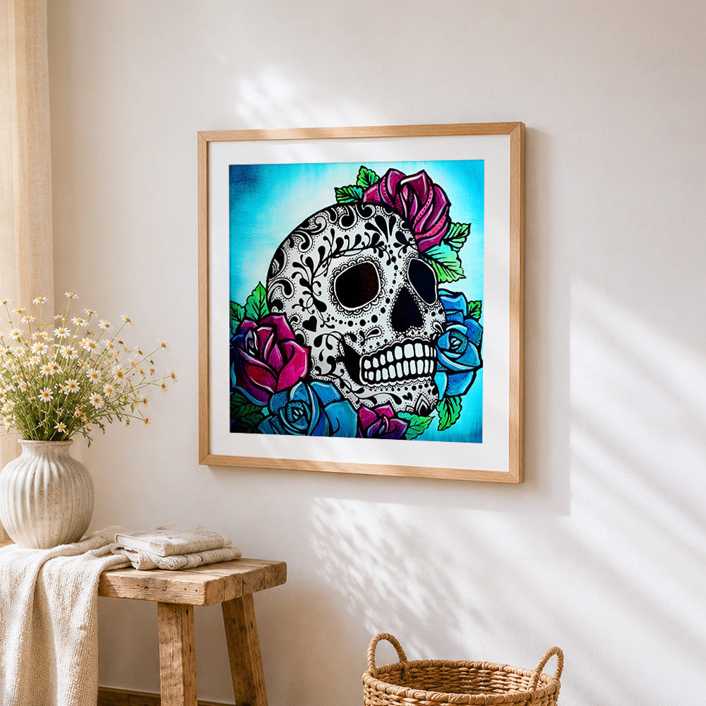 Sugar skull with red and blue roses cross stitch artwork displayed on wall as home decor
