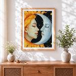 Finished sun and moon faces cross stitch artwork displayed
