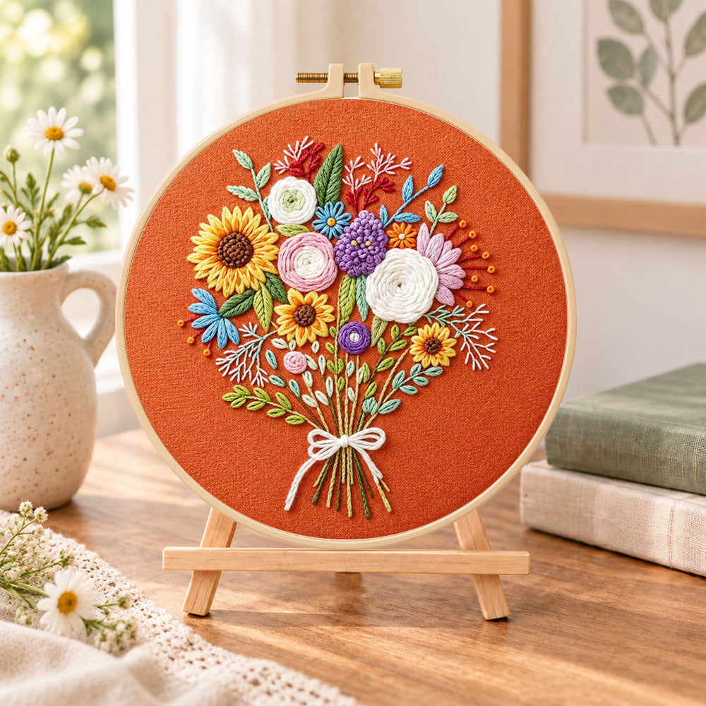 Sunflower bouquet on rust embroidery kit finished hoop displayed on a wooden stand as cosy tabletop decor