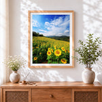 Finished sunflower field and rolling hills cross stitch artwork displayed
