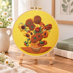 Sunflowers on golden background embroidery kit finished hoop displayed on a wooden stand as cosy tabletop decor