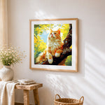 Sunlit ginger cat in a tree cross stitch artwork displayed on wall as home decor