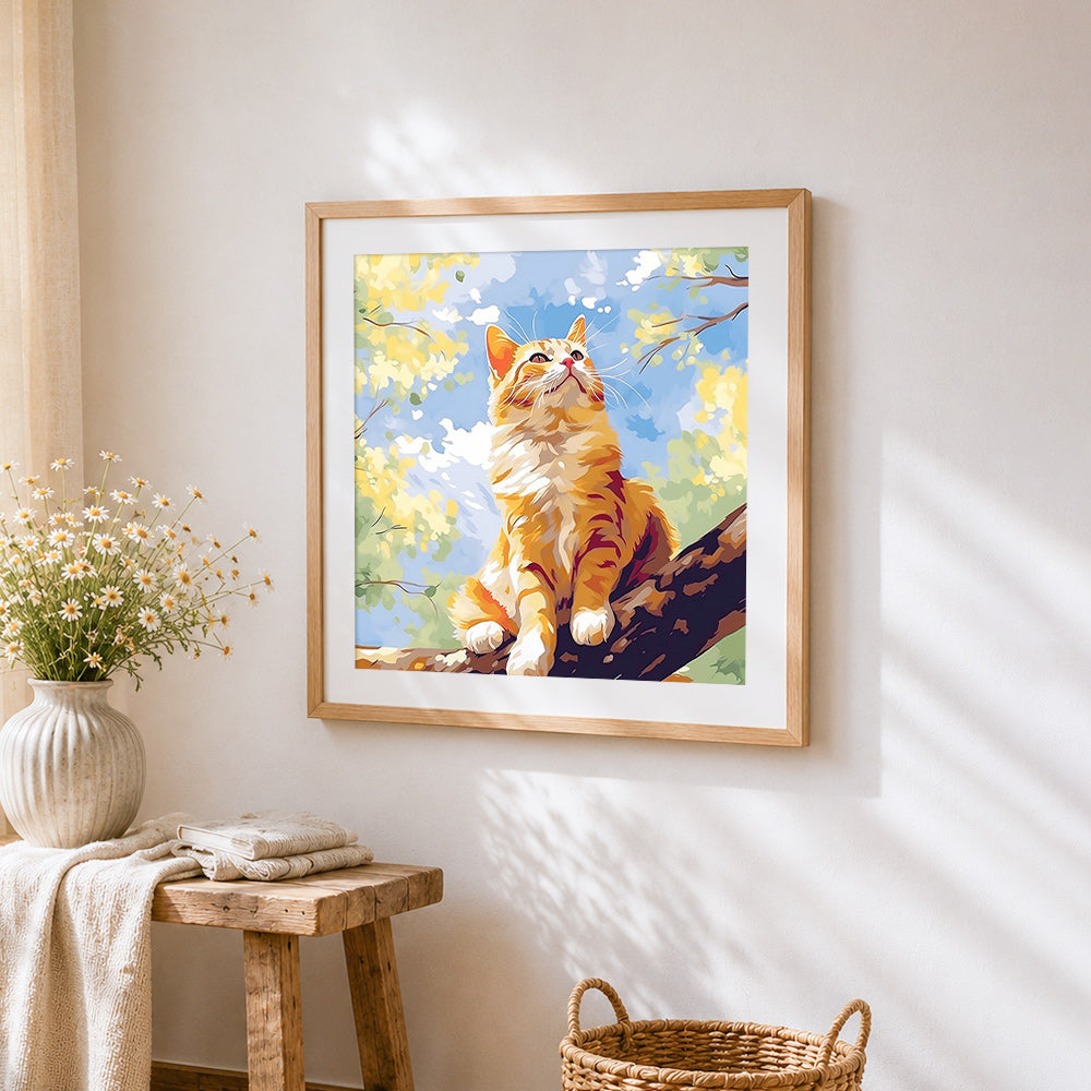 Sunlit ginger cat sitting in a tree cross stitch artwork displayed on wall as home decor