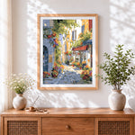 Finished sunlit italian cafe street cross stitch artwork displayed