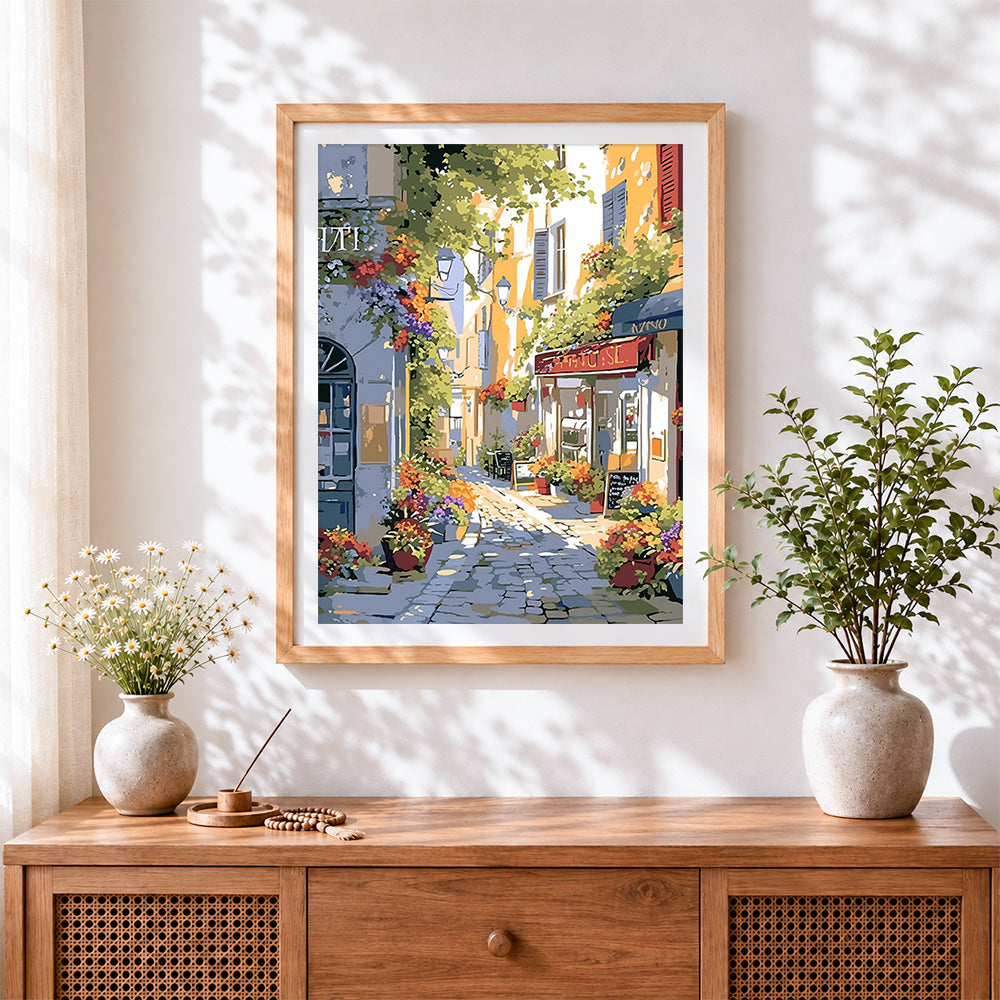 Finished sunlit italian cafe street cross stitch artwork displayed