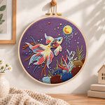 Sunlit underwater koi embroidery hoop wall art displayed as warm and cosy handmade home decor