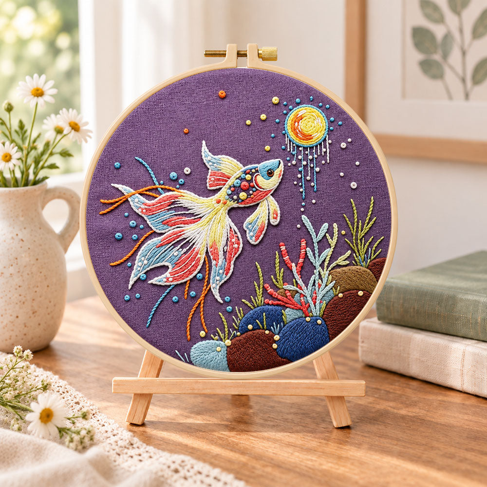 Sunlit underwater koi embroidery kit finished hoop displayed on a wooden stand as cosy tabletop decor