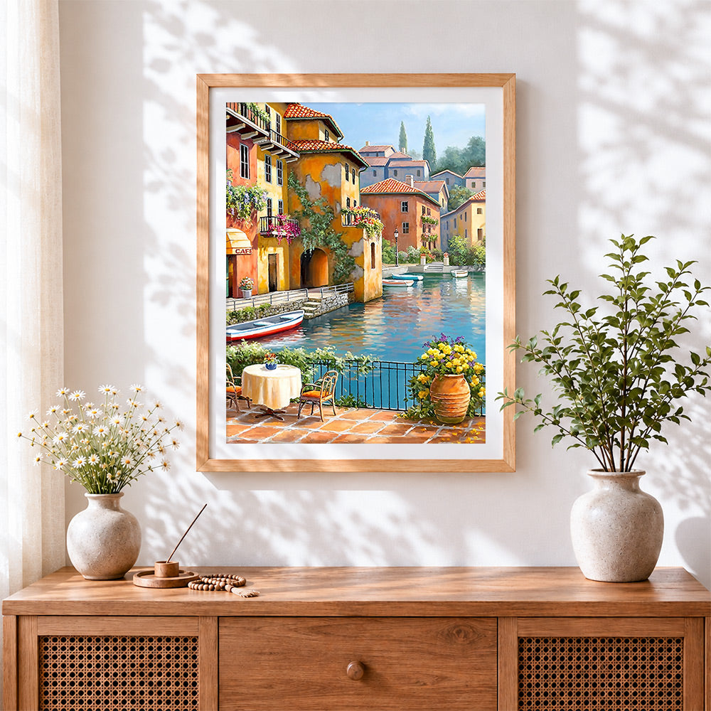 Finished sunlit waterside cafe with flowers paint by numbers artwork displayed as home decor