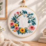 Sunny floral wreath and letter m embroidery hoop wall art displayed as warm and cosy handmade home decor
