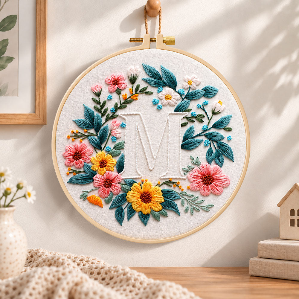 Sunny floral wreath and letter m embroidery hoop wall art displayed as warm and cosy handmade home decor