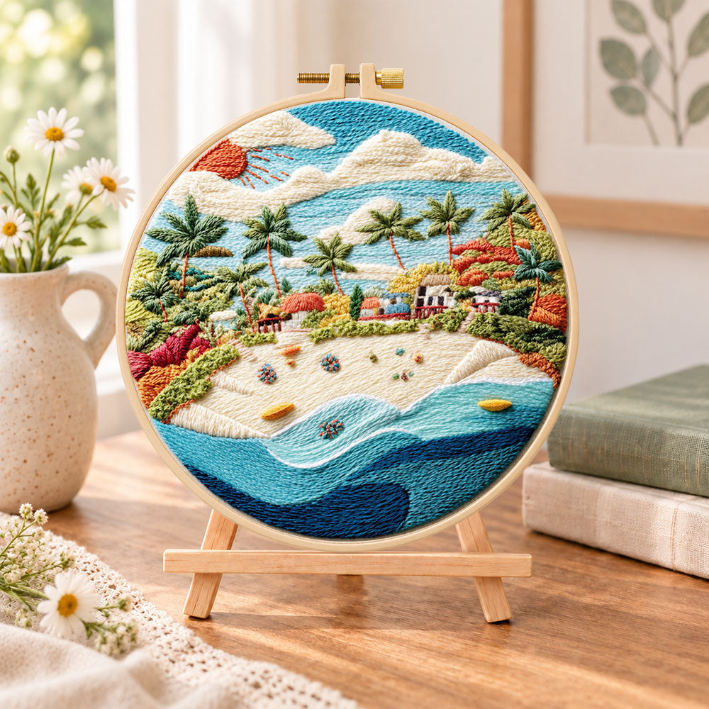 Sunny tropical beach embroidery kit finished hoop displayed on a wooden stand as cosy tabletop decor