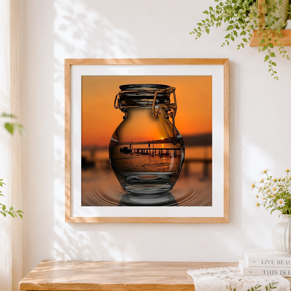 Finished sunset pier in glass jar cross stitch artwork displayed