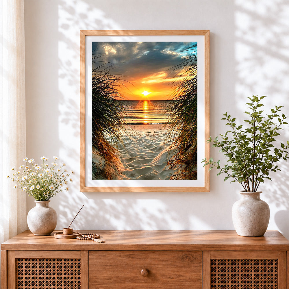 Finished sunset through beach and grass cross stitch artwork displayed