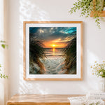 Finished sunset through beach dune grass cross stitch artwork displayed