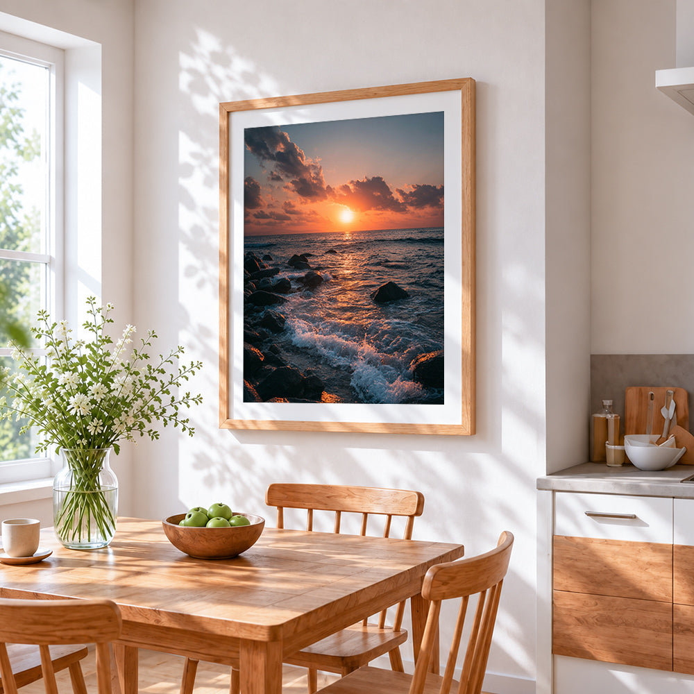 Sunset waves crashing on rocky shore cross stitch artwork displayed on wall as home decor