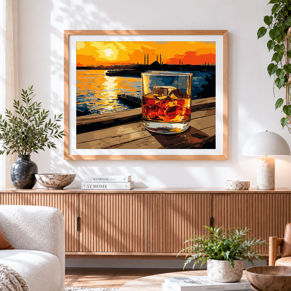 Finished sunset whisky glass cross stitch artwork displayed