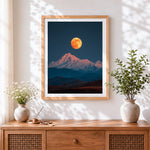Finished super moon over snowy mountain cross stitch artwork displayed