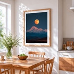 Super moon over snowy mountain cross stitch artwork displayed on wall as home decor