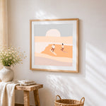 Surfers at sunset cross stitch artwork displayed on wall as home decor