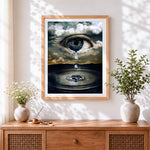 Finished surreal eye in clouds with tear cross stitch artwork displayed