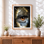 Finished surreal eye of nature cross stitch artwork displayed