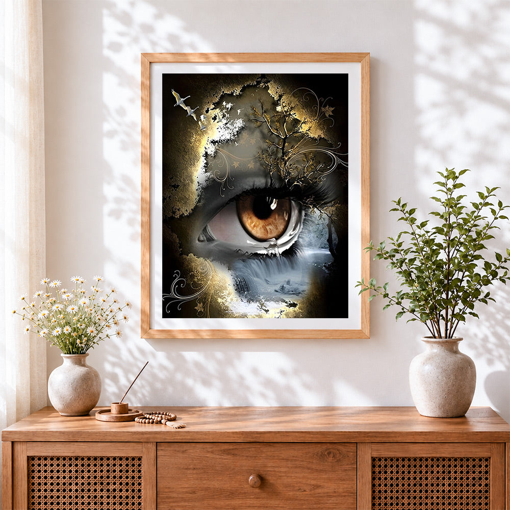 Finished surreal eye of nature cross stitch artwork displayed
