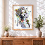 Finished surreal female portrait cross stitch artwork displayed