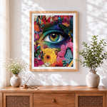 Finished surreal floral eye with butterflies cross stitch artwork displayed