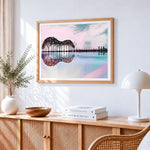 Surreal guitar shaped trees and city reflection cross stitch artwork displayed on wall as home decor