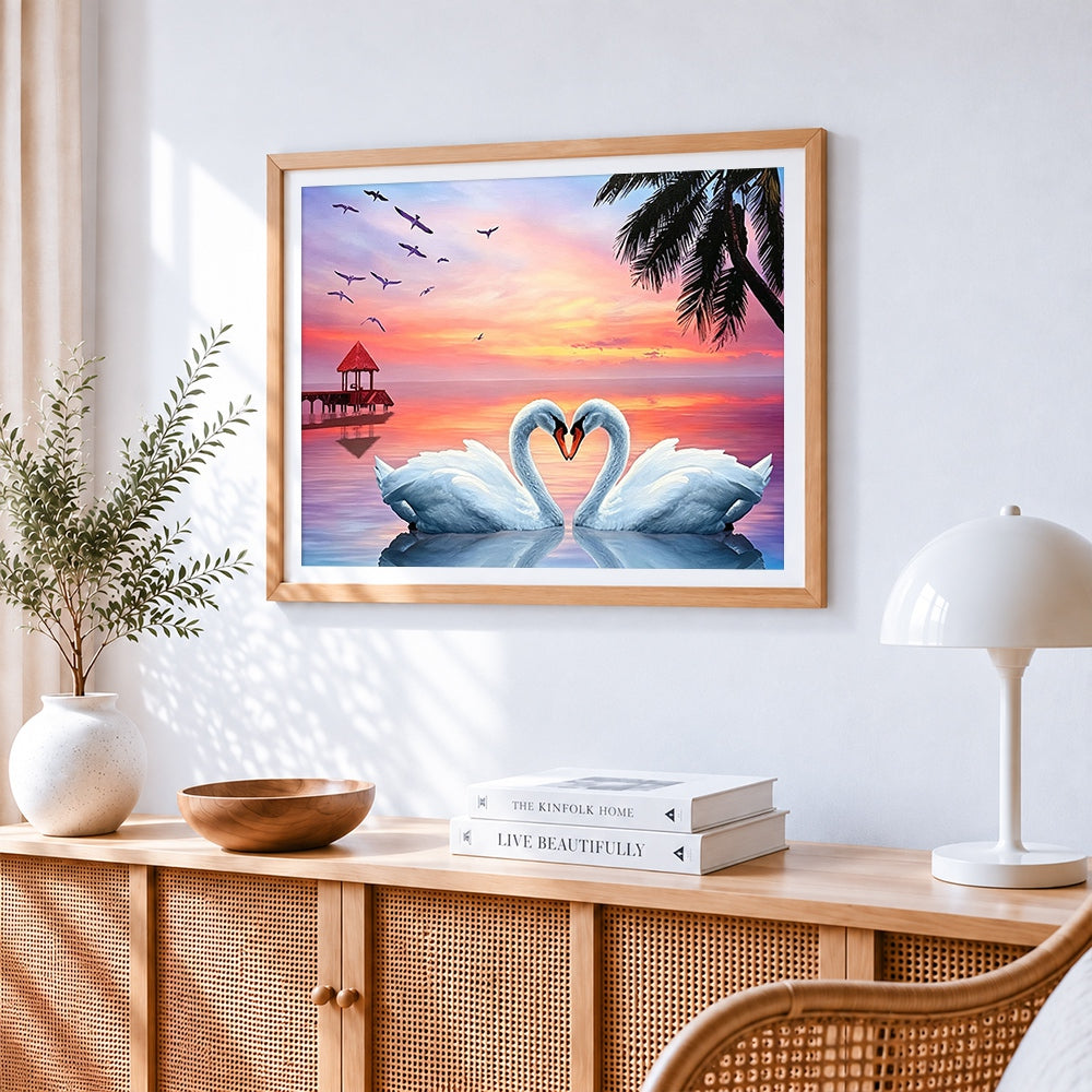 Swans forming a heart at sunset cross stitch artwork displayed on wall as home decor