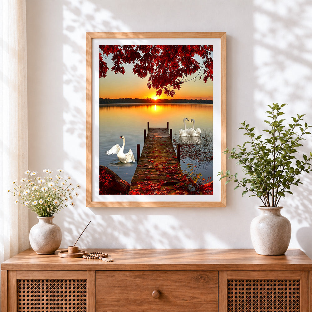 Finished swans on a lake at sunset cross stitch artwork displayed