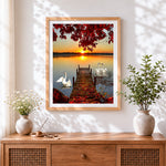 Finished swans on a lake at sunset paint by numbers artwork displayed as home decor