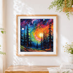 Finished swirling cosmic forest cross stitch artwork displayed