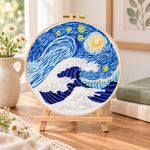 Swirling ocean waves embroidery kit finished hoop displayed on a wooden stand as cosy tabletop decor