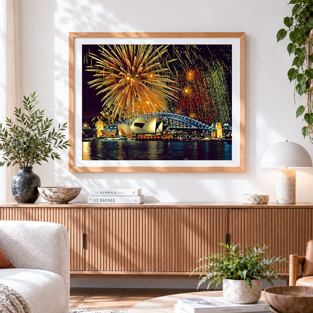Finished sydney opera house and fireworks cross stitch artwork displayed