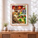 Finished tabby cat and mouse by a christmas tree cross stitch artwork displayed