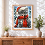 Finished tabby cat in a santa hat and red scarf cross stitch artwork displayed