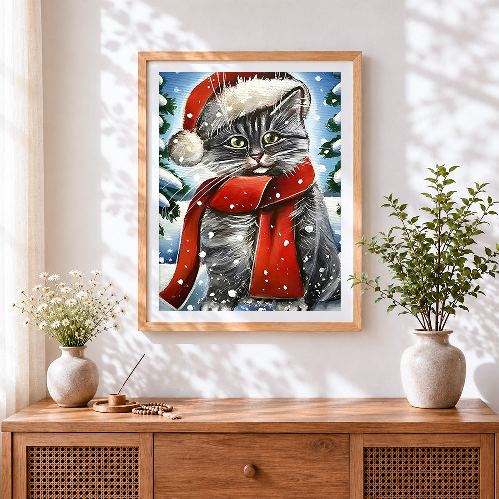 Finished tabby cat in a santa hat and red scarf cross stitch artwork displayed