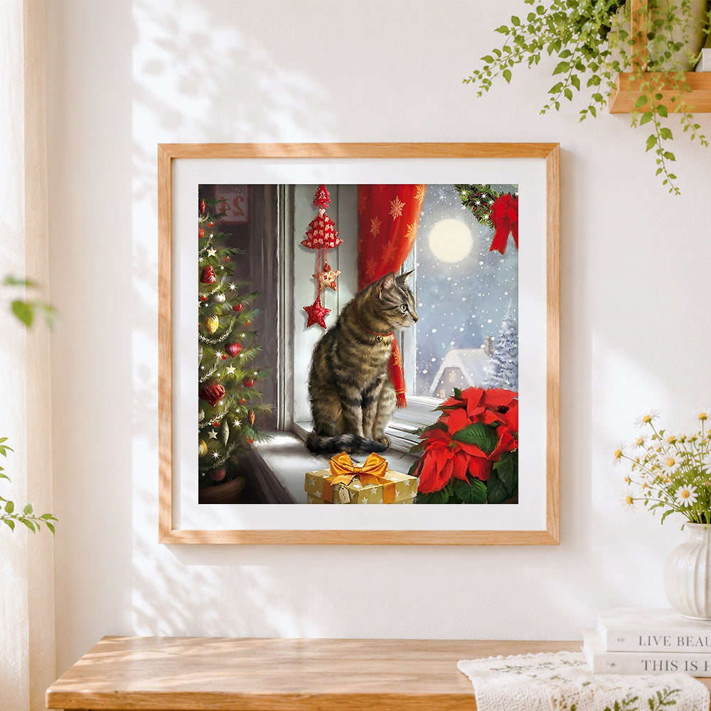 Finished tabby cat watching snowfall cross stitch artwork displayed
