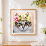 Finished tabby cat with flower crown cross stitch artwork displayed