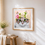 Tabby cat with flower crown cross stitch artwork displayed on wall as home decor