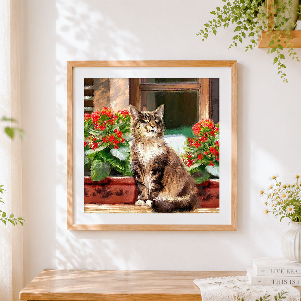 Finished tabby cat with red flowers cross stitch artwork displayed