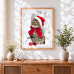 Finished tabby cat with santa hat and red bow cross stitch artwork displayed