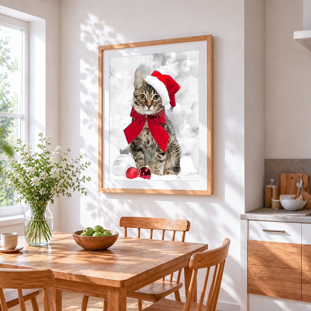 Tabby cat with santa hat and red bow cross stitch artwork displayed on wall as home decor