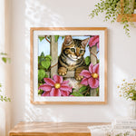 Finished tabby kitten on garden trellis cross stitch artwork displayed