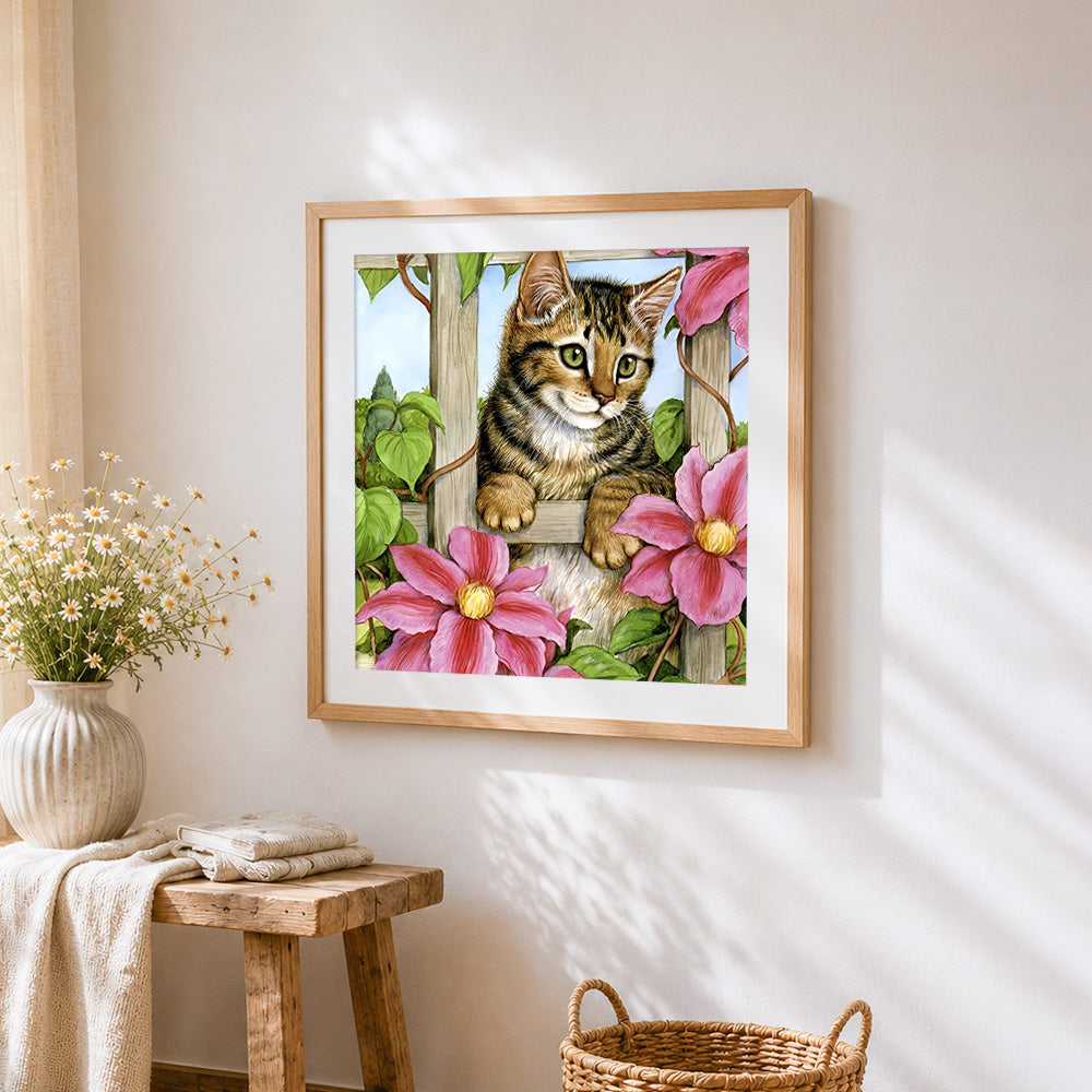 Tabby kitten on garden trellis cross stitch artwork displayed on wall as home decor