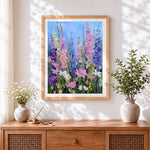 Finished tall pink and blue wildflowers cross stitch artwork displayed