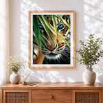 Finished teal eyed tiger and bamboo cross stitch artwork displayed